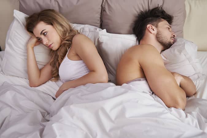 Couple Turned Away From Each Other In Bed