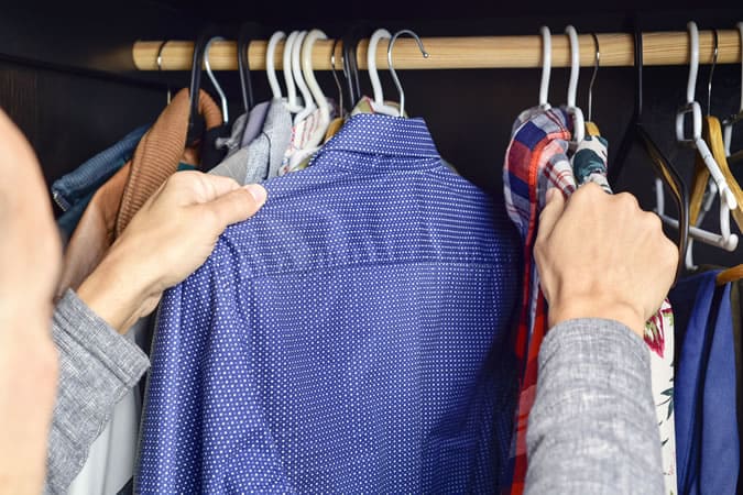 Man looking in wardrobe