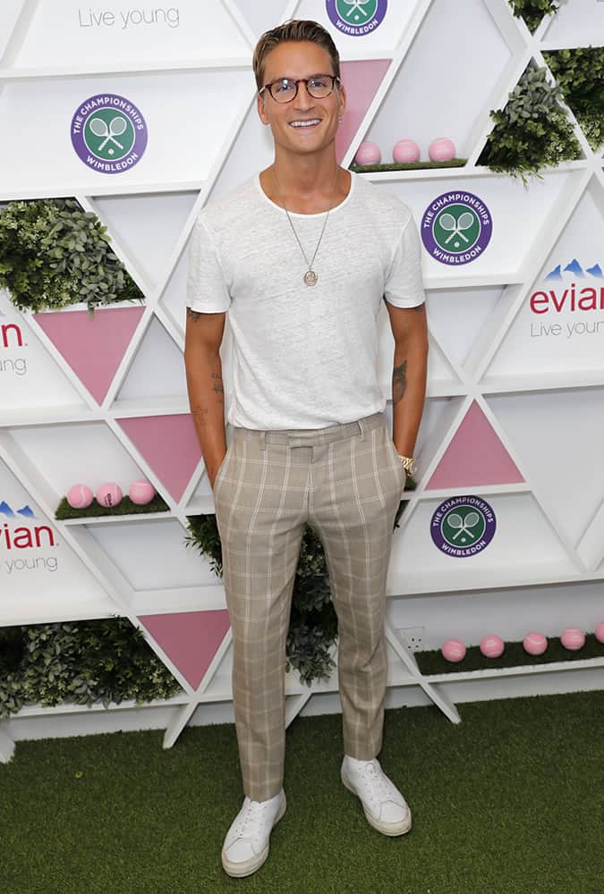 Oliver Proudlock wearing check trousers and a white t-shirt
