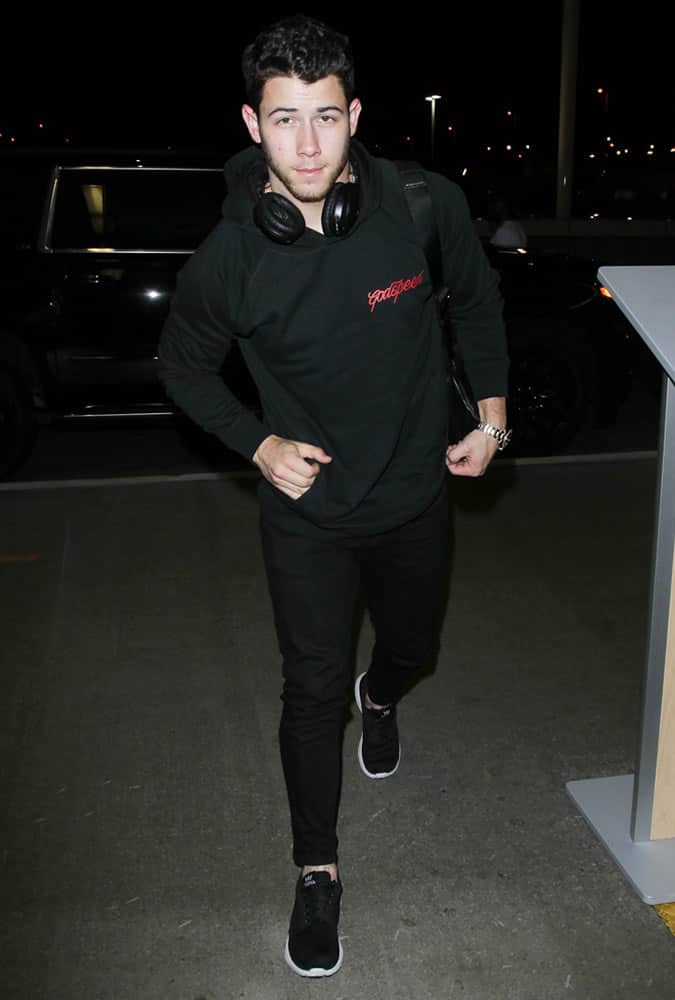 Nick Jonas wearing a black hoodie