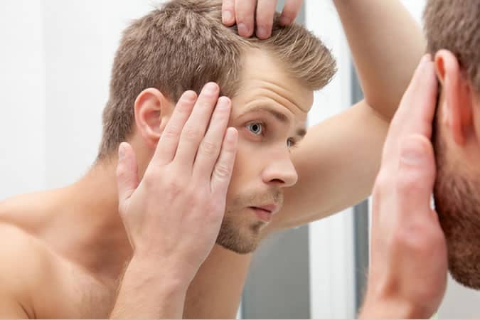 man checking hair