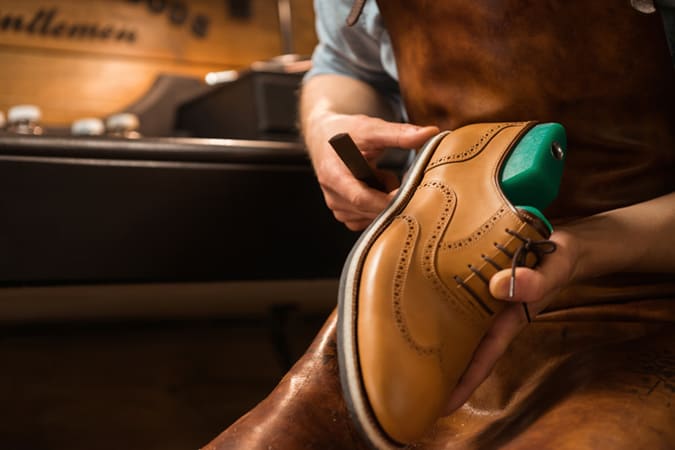 A Cobbler Working On Some Shoes