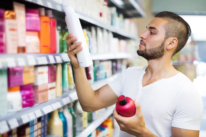 Man checking hair product labels