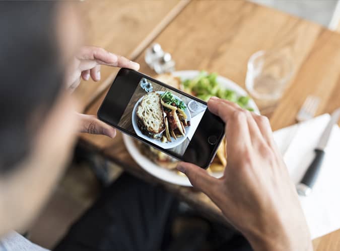 Man taking photo of food