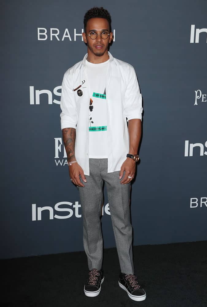 Lewis Hamilton wearing check trousers and a white shirt