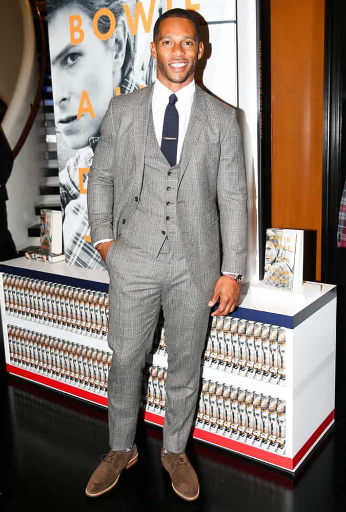 Victor Cruz wearing a three-piece suit