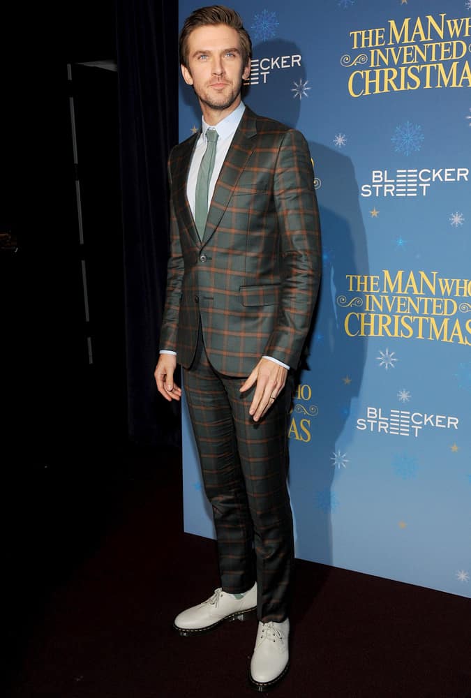 TDan Stevens wearing a windowpane check suit at the premiere of The Man Who Invented Christmas