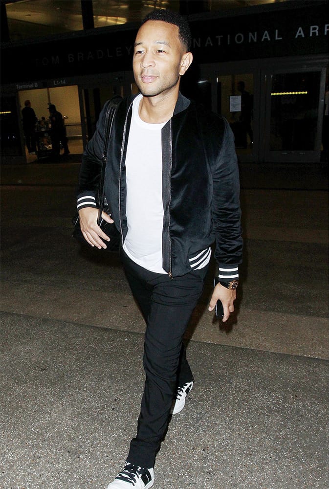 John Legend wearing a black and white bomber jacket