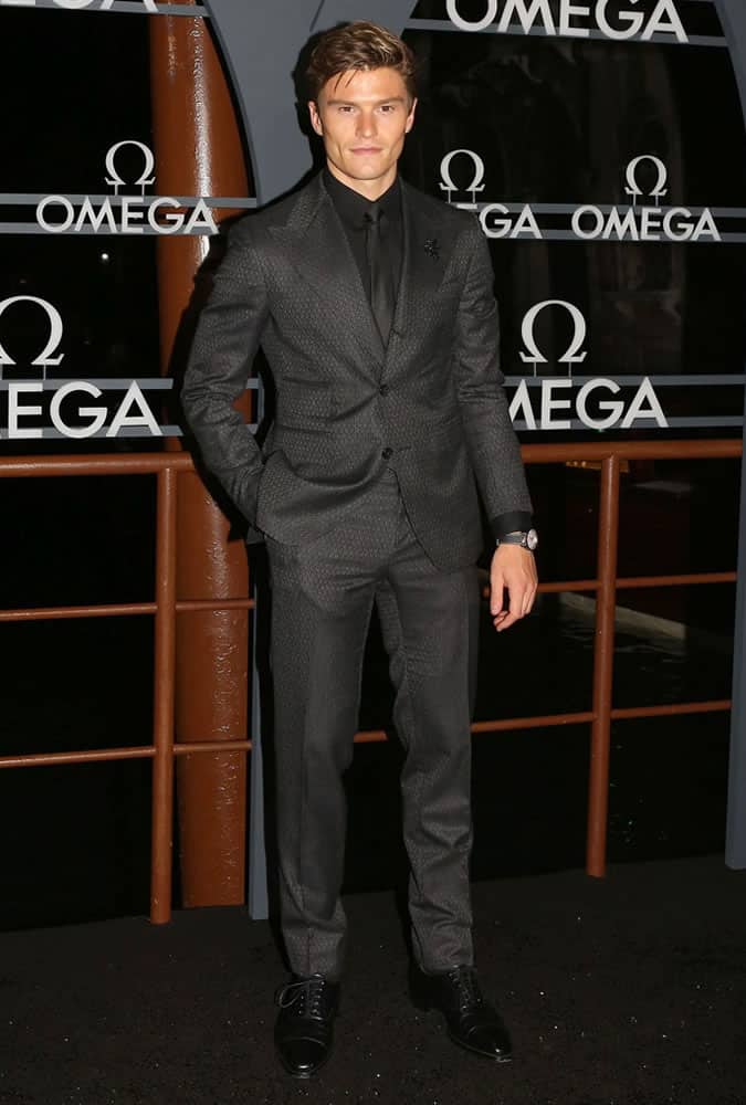Oliver Cheshire dressed in a monochrome suit at an Omega event