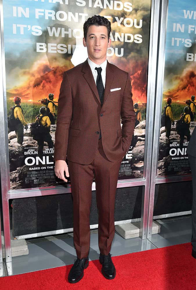 Miles Teller wearing a rust-coloured suit