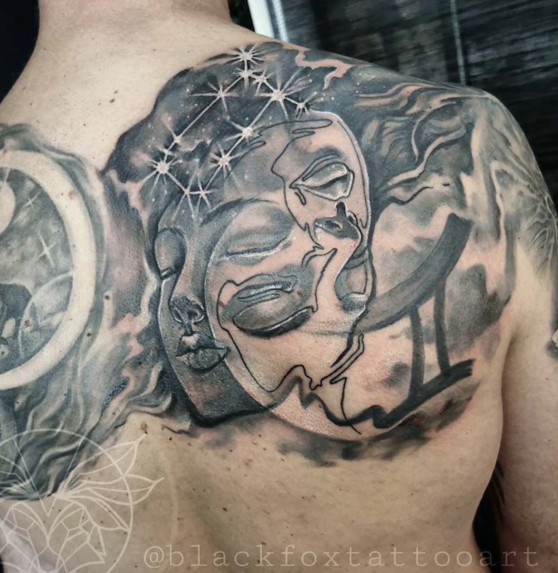 Man with Gemini tattoo on his back 