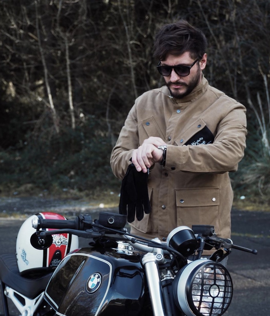 Man in front of a bike, in the best waxed jacket