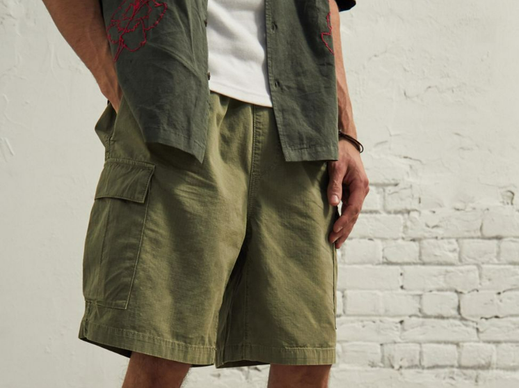 Man wearing cargo shorts with one hand in pocket