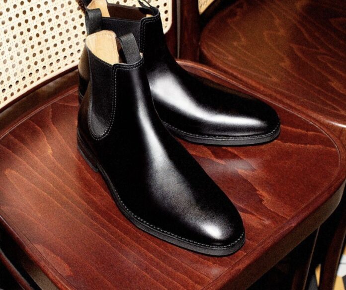 pair of the best chelsea boots for men sitting on a chair