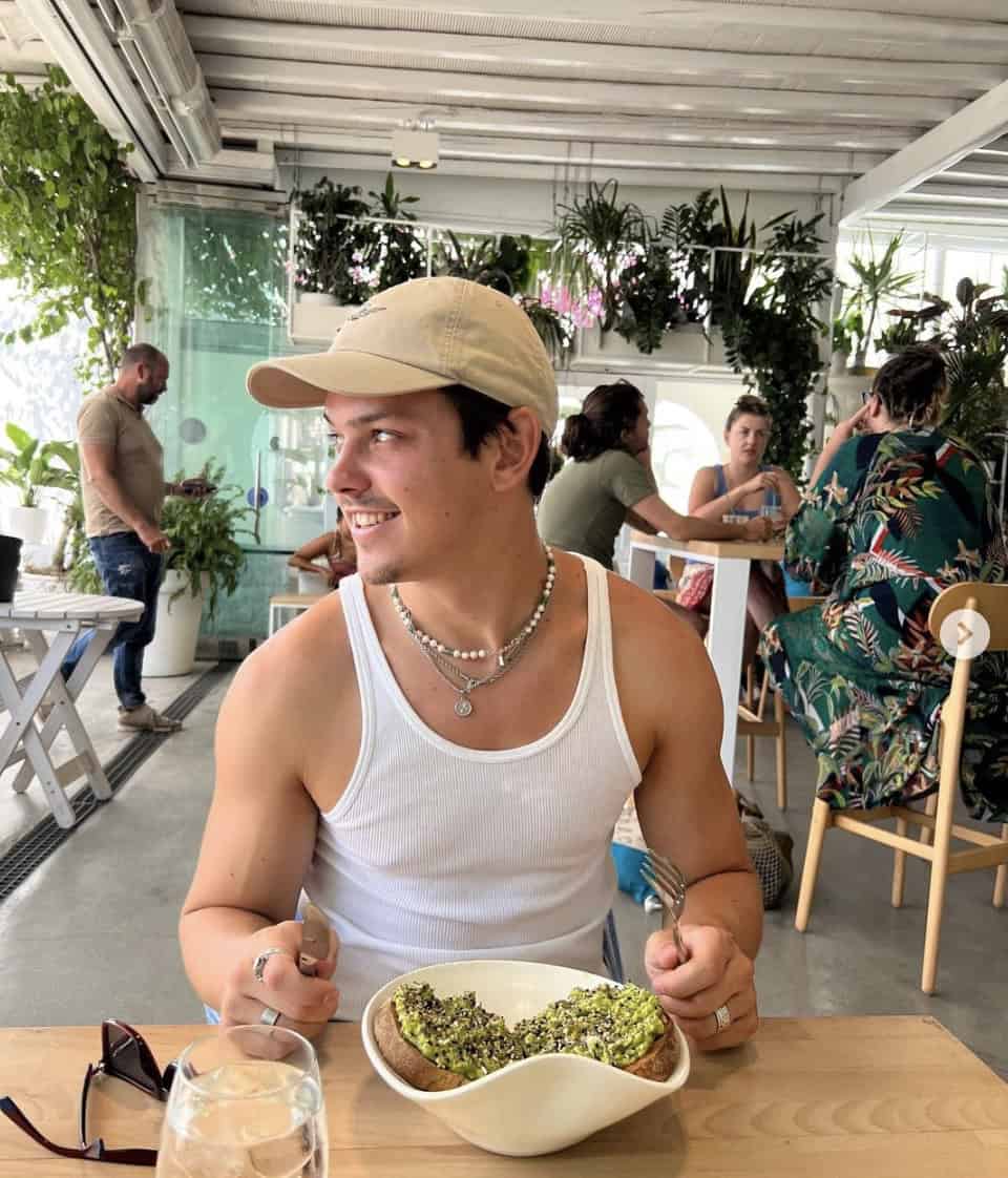 man at a restaurant looking away from the camera in an undershirt