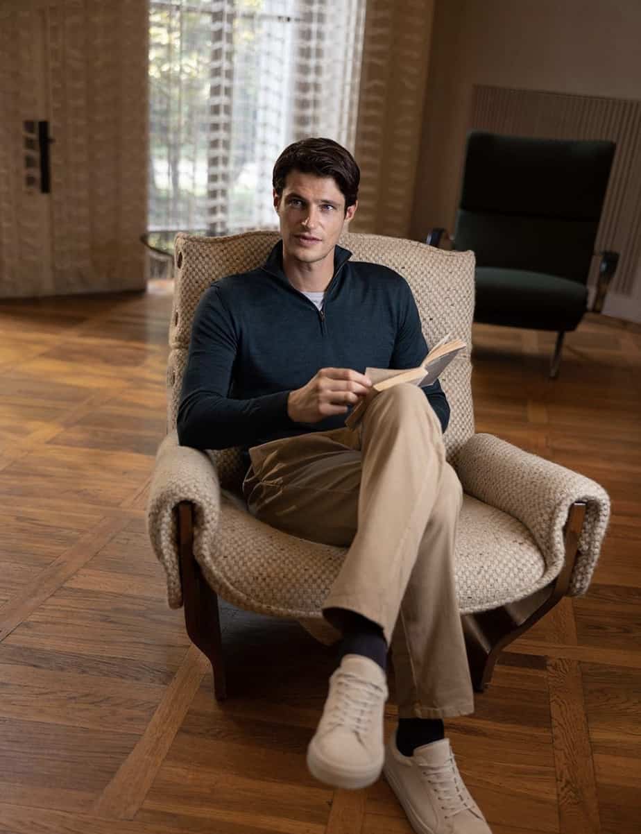 man sitting on a chair with a book, modeling Luca Faloni clothes