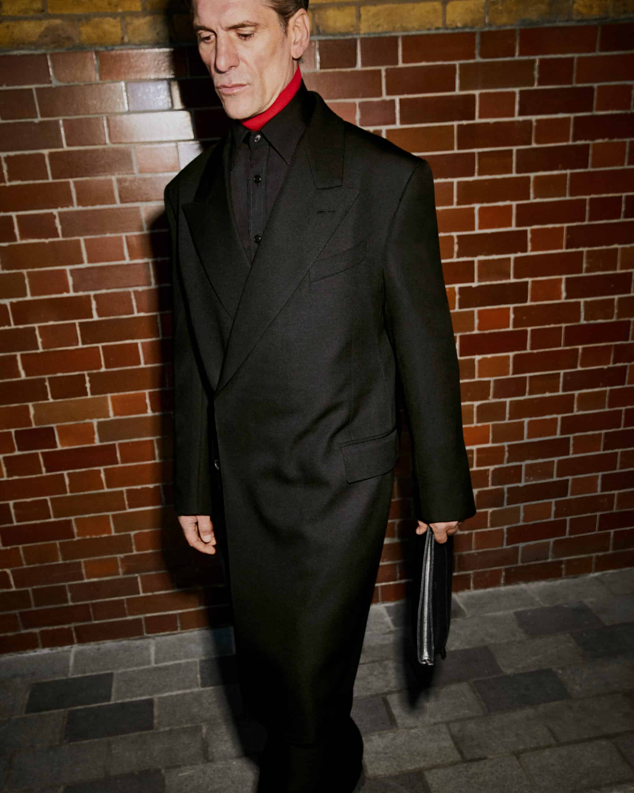 man in dark a suit walking at night