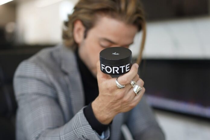 man in a suit holding up forte series product