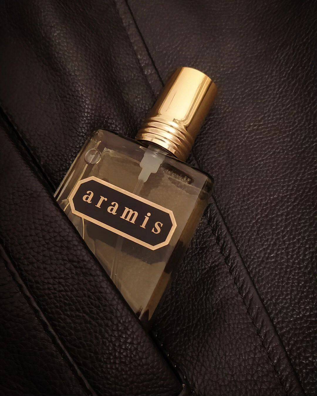 a bottle of aramis cologne tucked in a leather jacket pocket
