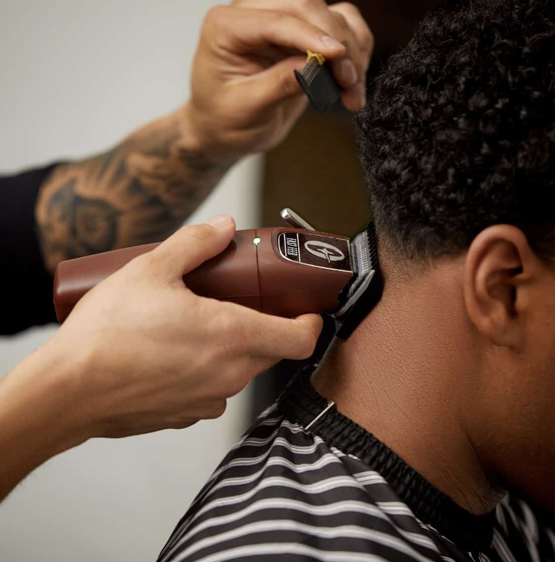 man cutting hair with clippers