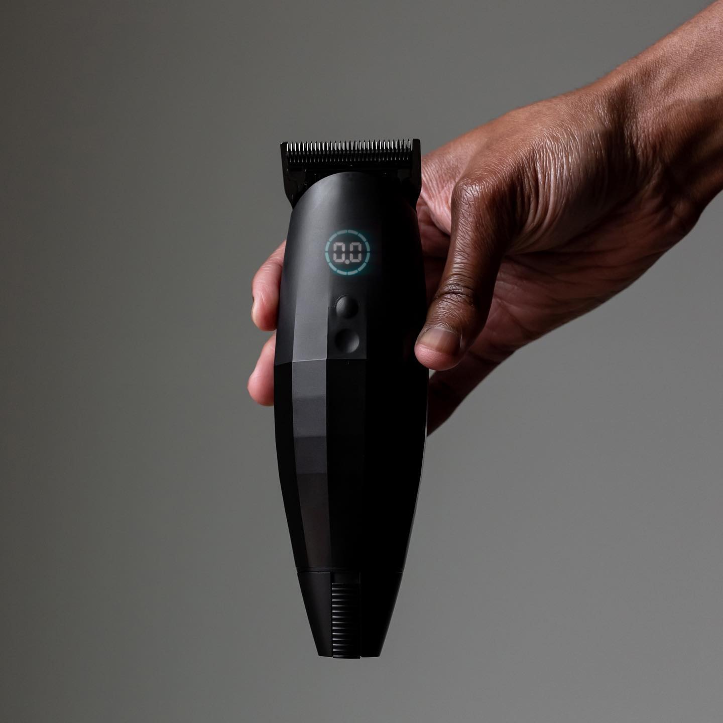 holding a Bevel beard trimmer with built-in vacuum