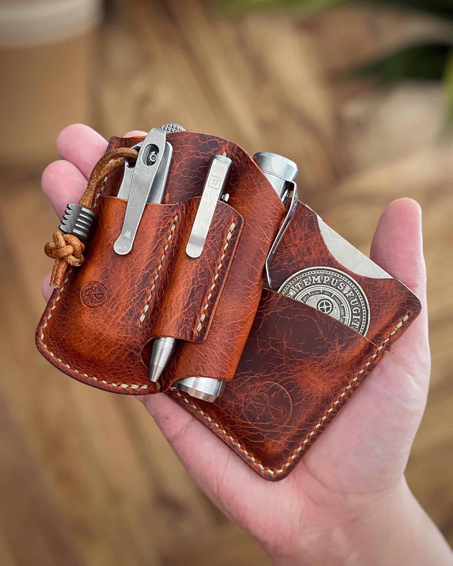 holding a customized leather wallet