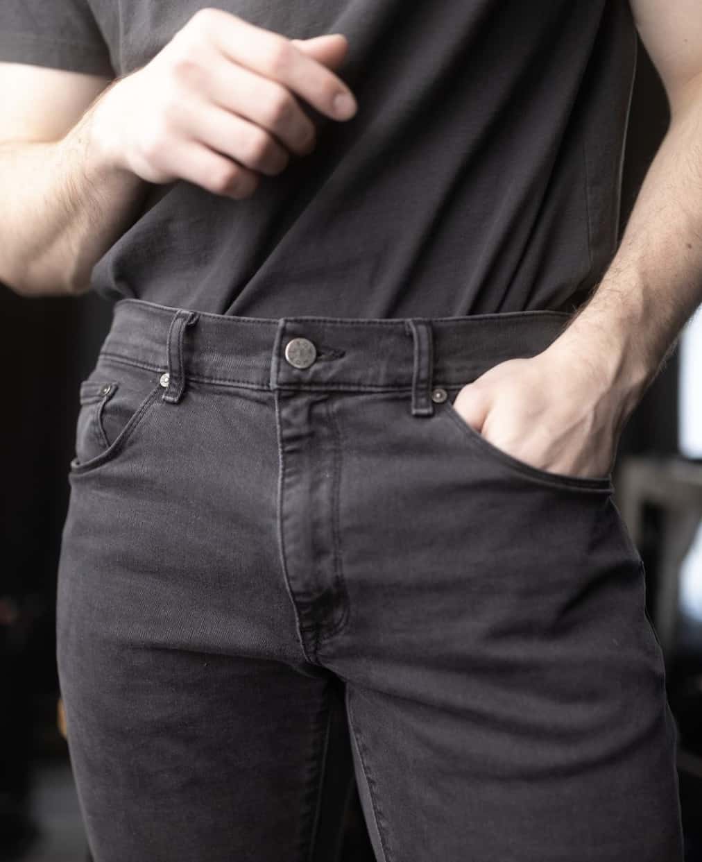 close up of a man in black Mott & Bow Jeans and a black t-shirt