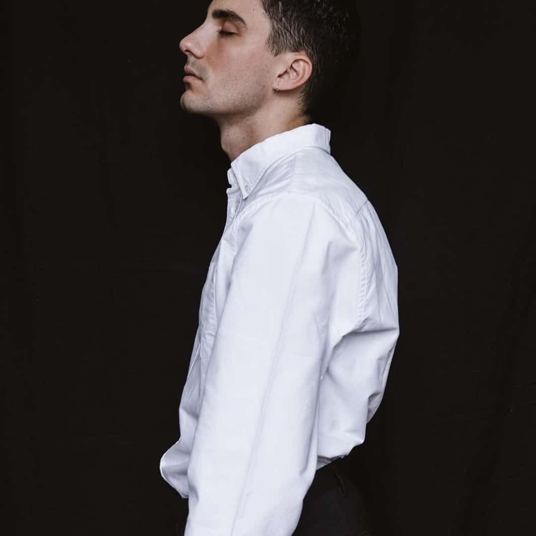 man in a tucked-in white oxford shirt