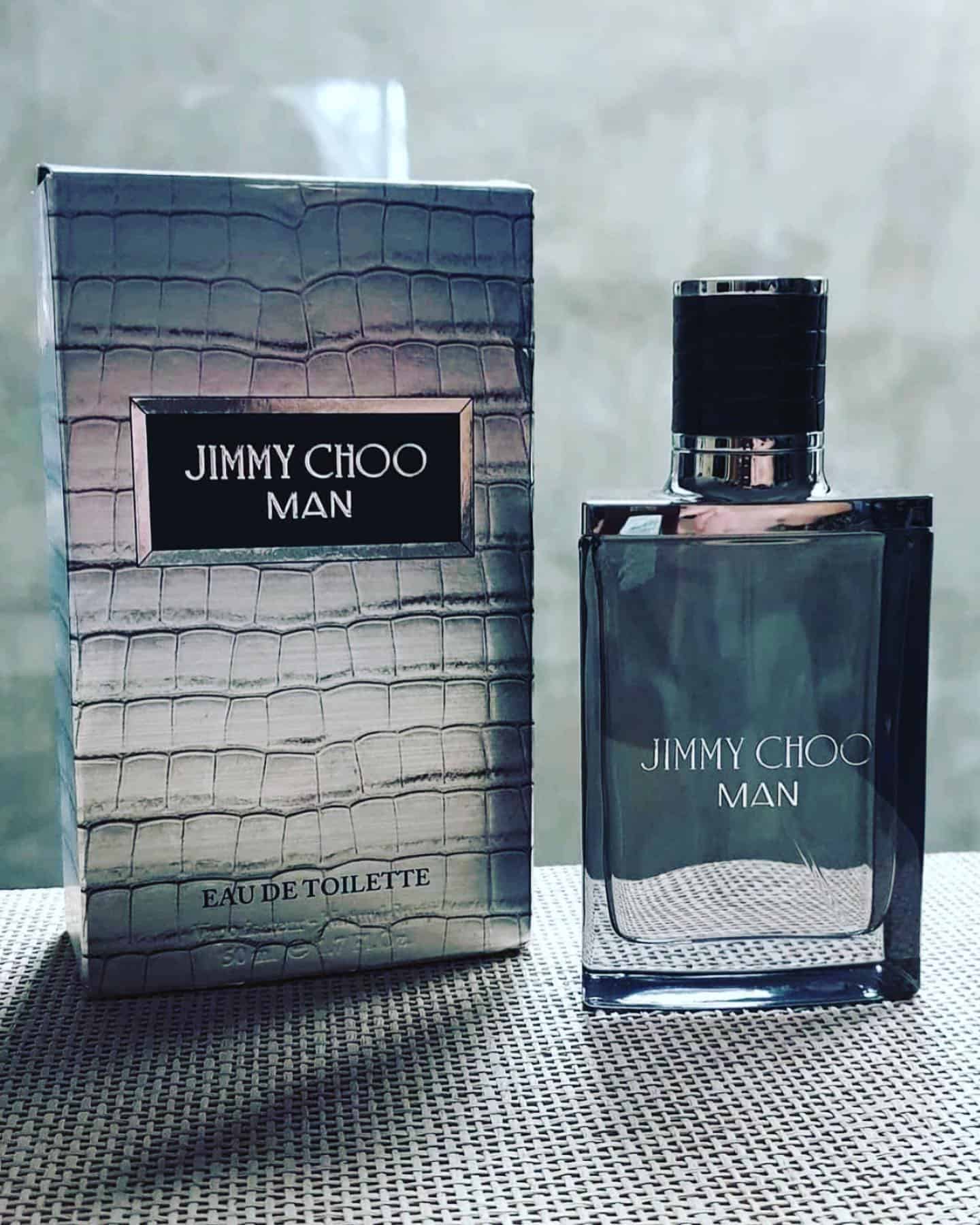 a box and a bottle of jimmy choo man by the window sill