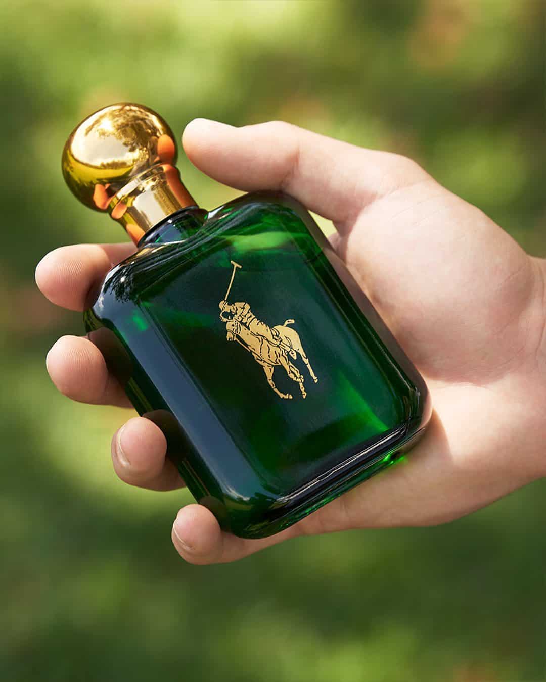 holding a bottle of ralph lauren polo cologne