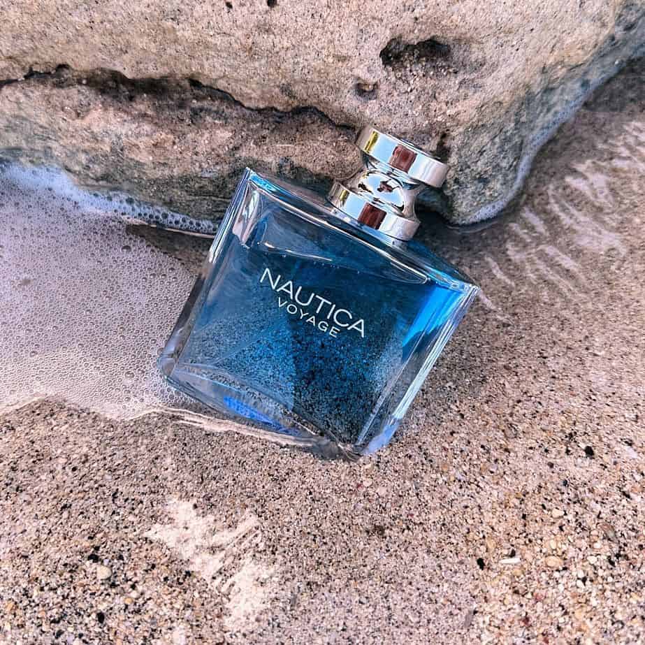 a bottle of nautica voyage on the sand