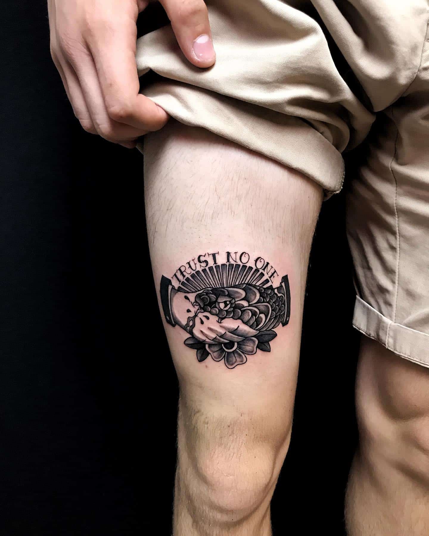 trust no one tattoo on the leg