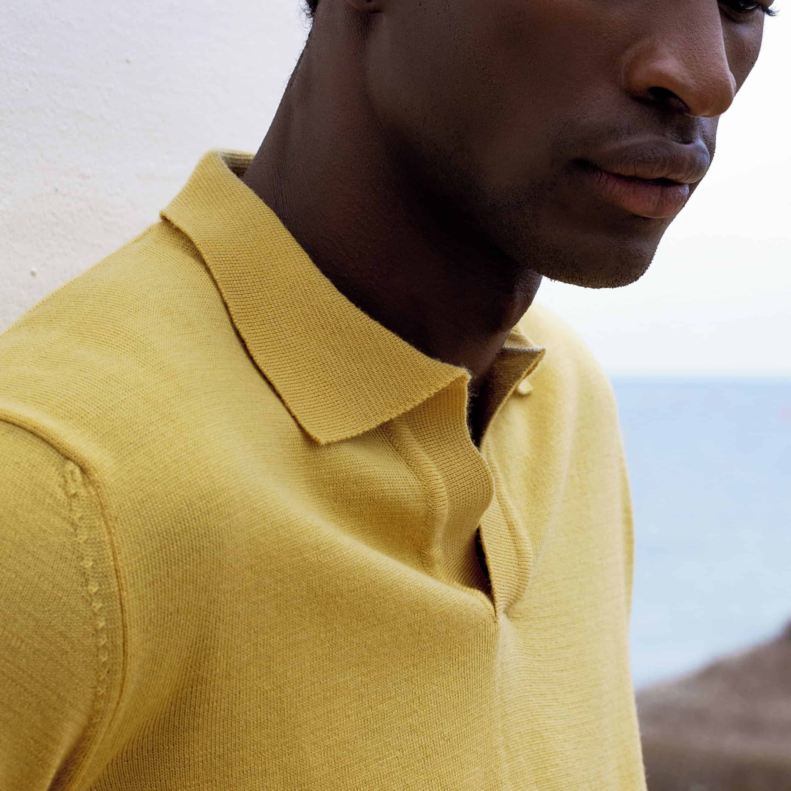 man wearing a knitted polo shirt