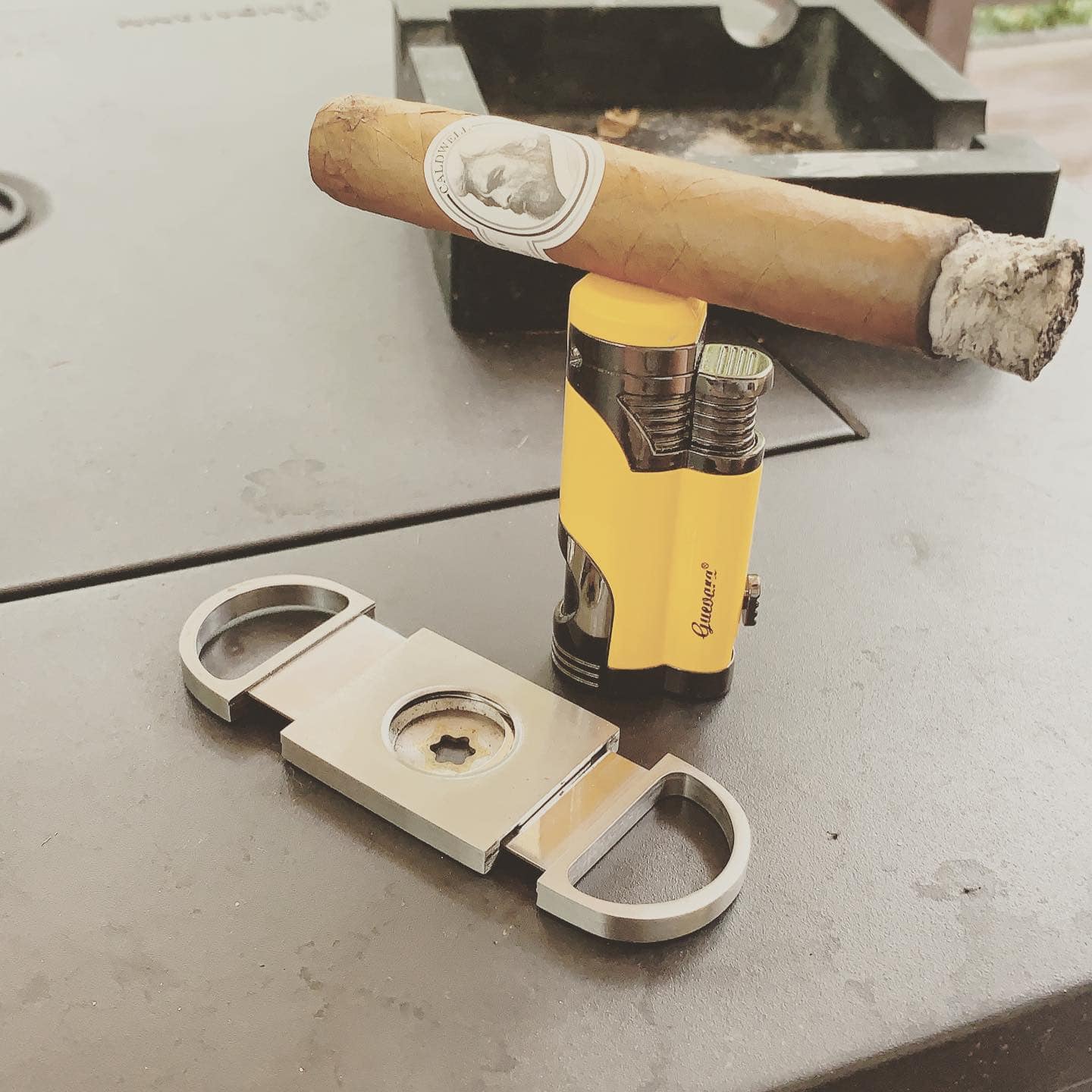 cigar balanced on top of a lighter