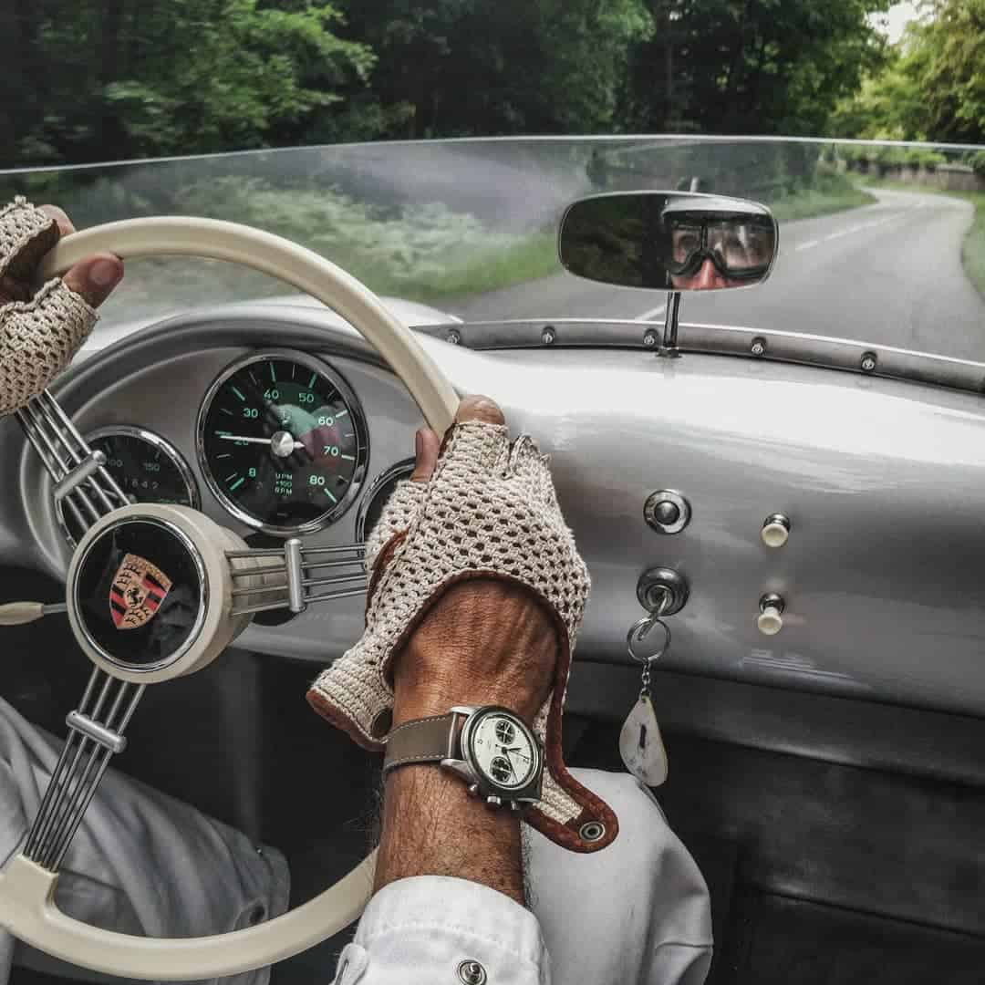 man driving a classic sports car
