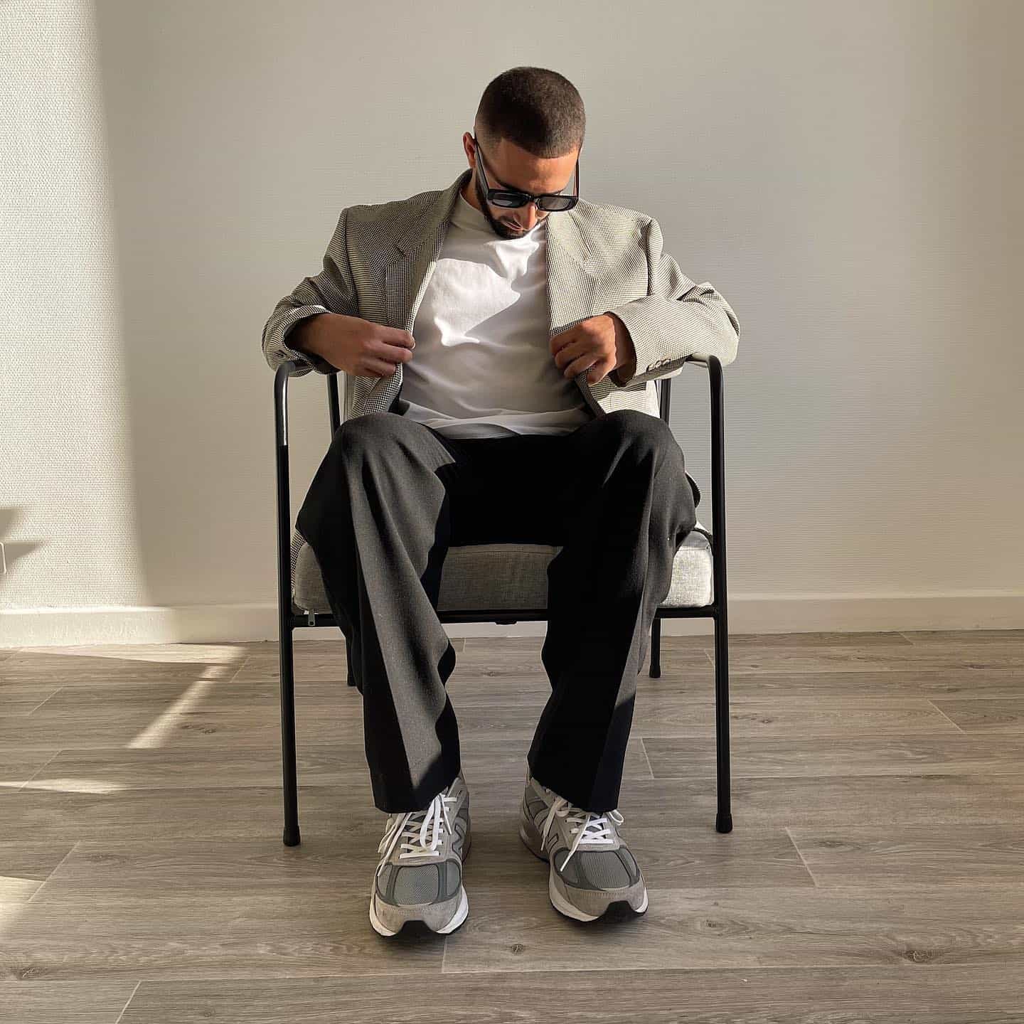 man in a blazer sitting on a chair