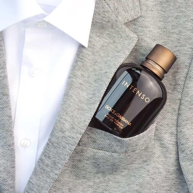 a bottle of dolce and gabbana intenso on front pocket of a suit