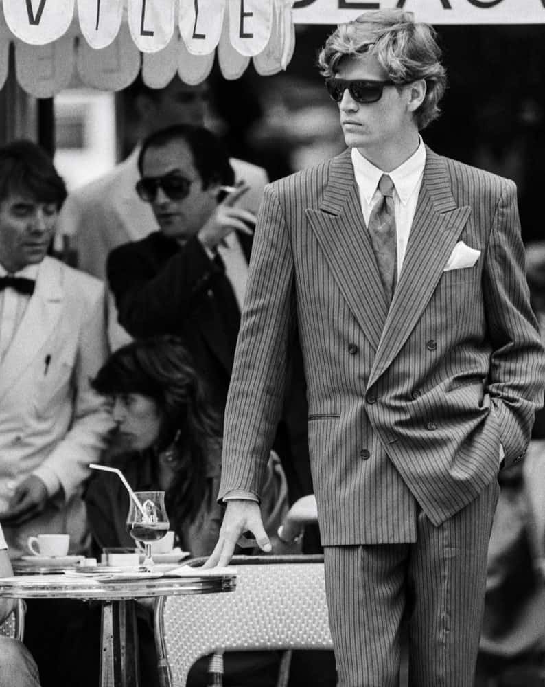 A man in 1980s wearing a striped double breasted suit