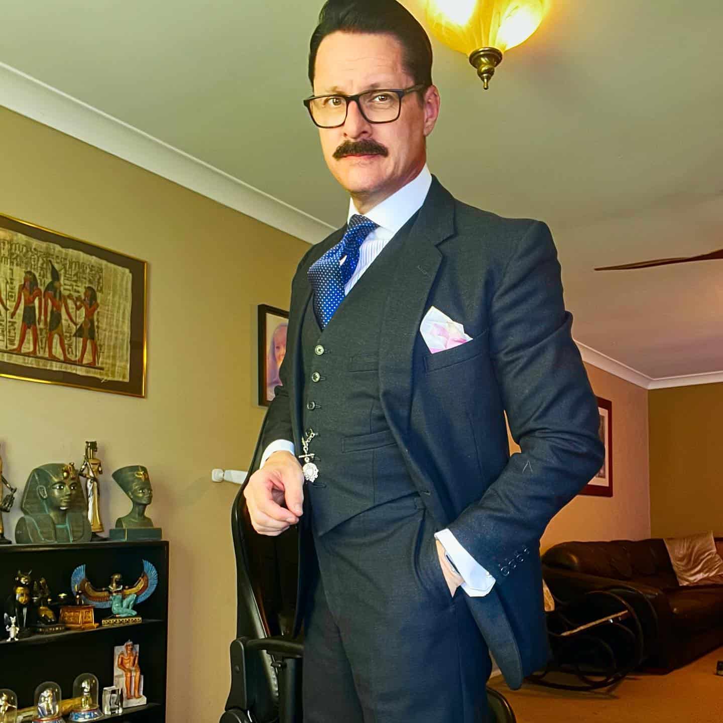 a man wearing a 1960s inspired three piece suit