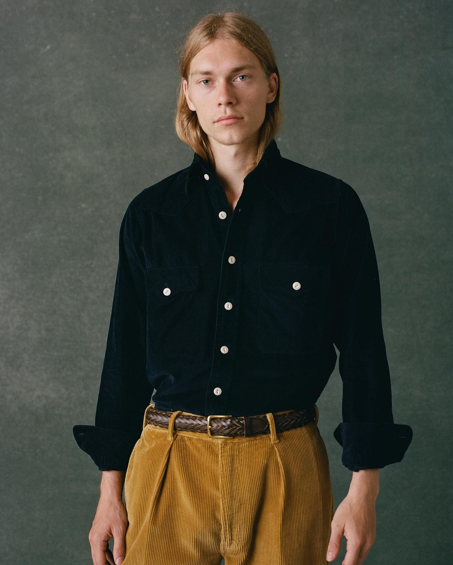 man in a navy corduroy shirt by drakes