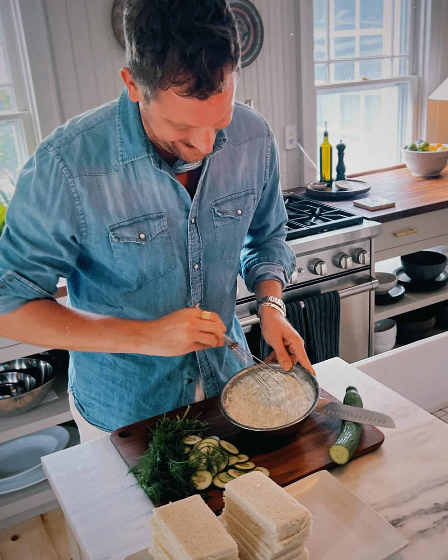 man in the kitchen preparing sandwiches