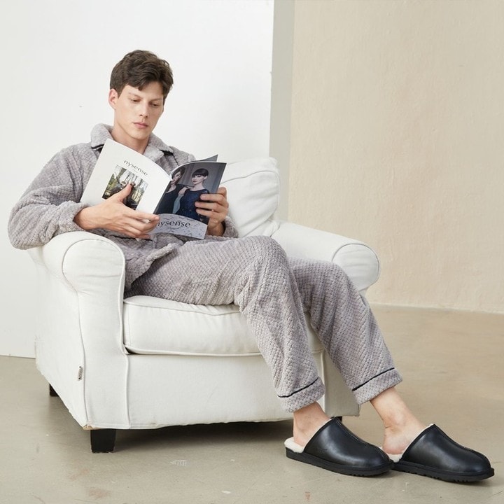 man sitting on the sofa reading a magazine