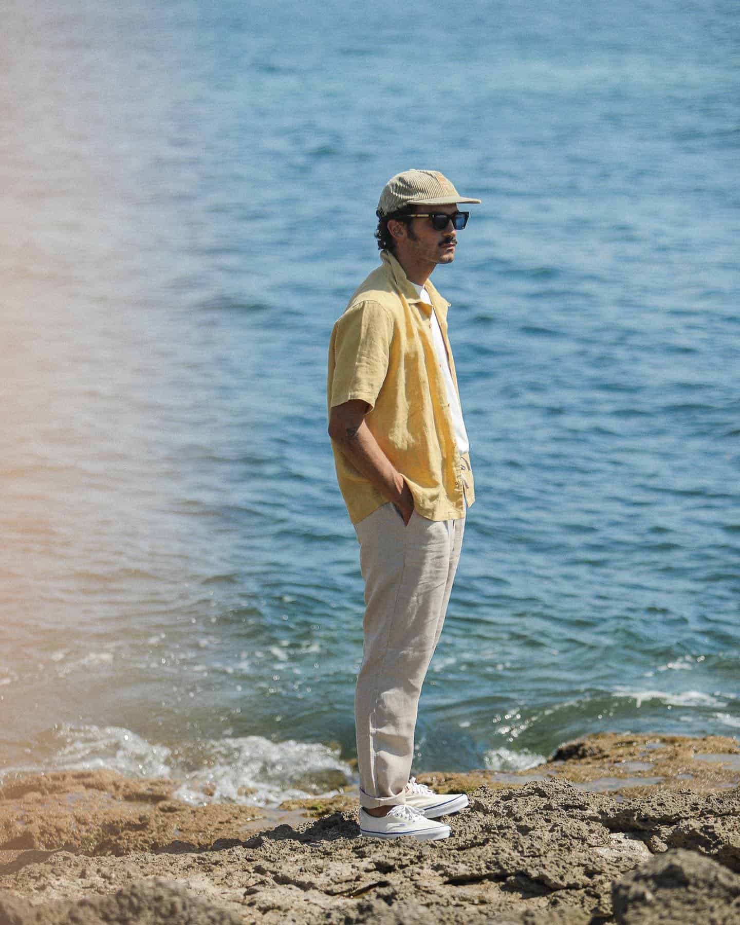 man in a linen shirt and pants by the sea