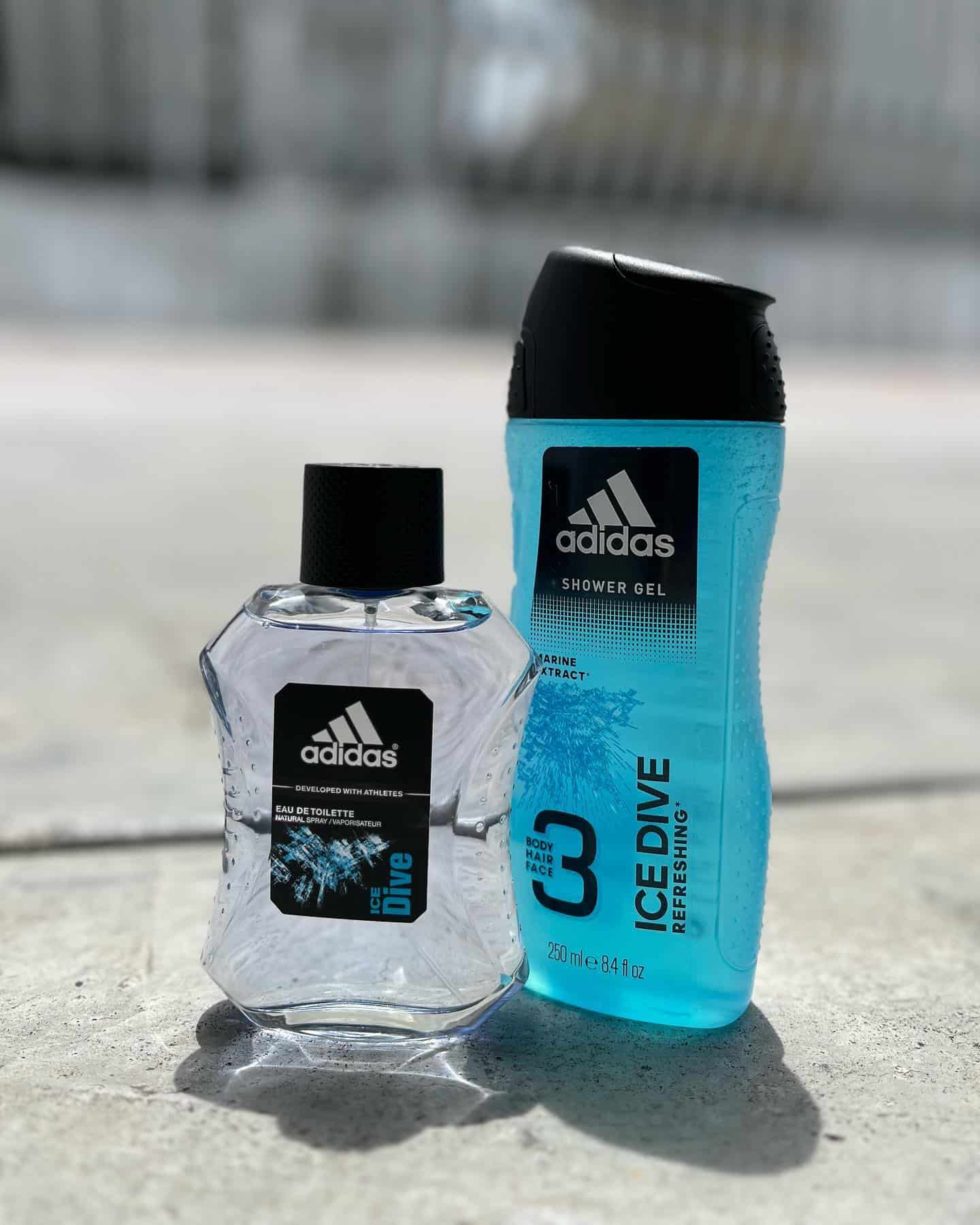bottles of adidas dive cologne and shower gel on the ground