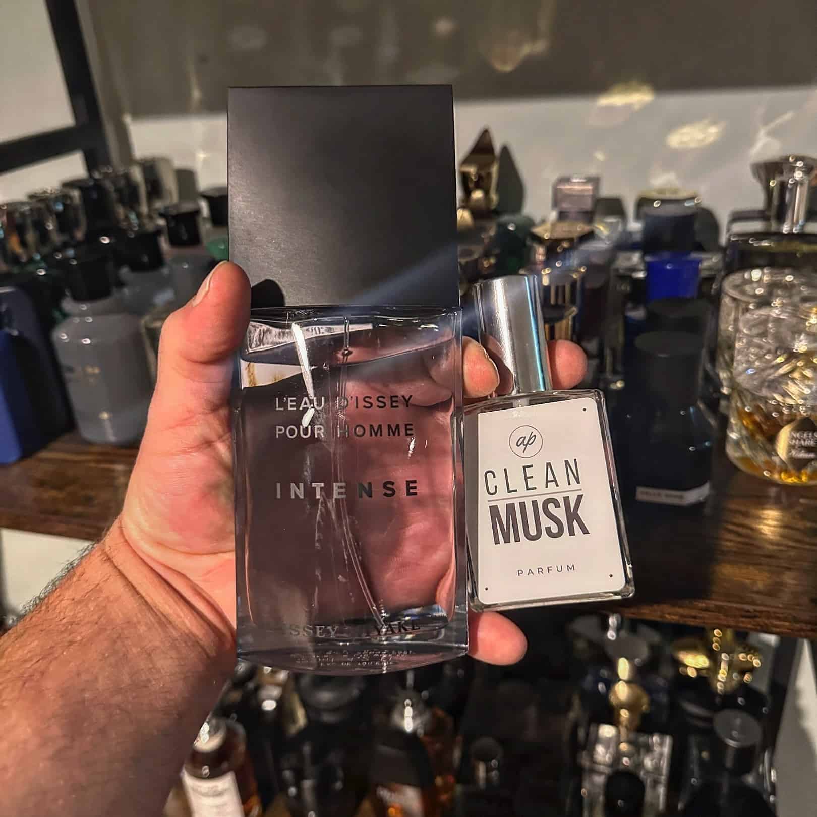 holding a bottle of l'eau d'issey pour homme intense and clean musk parfum
