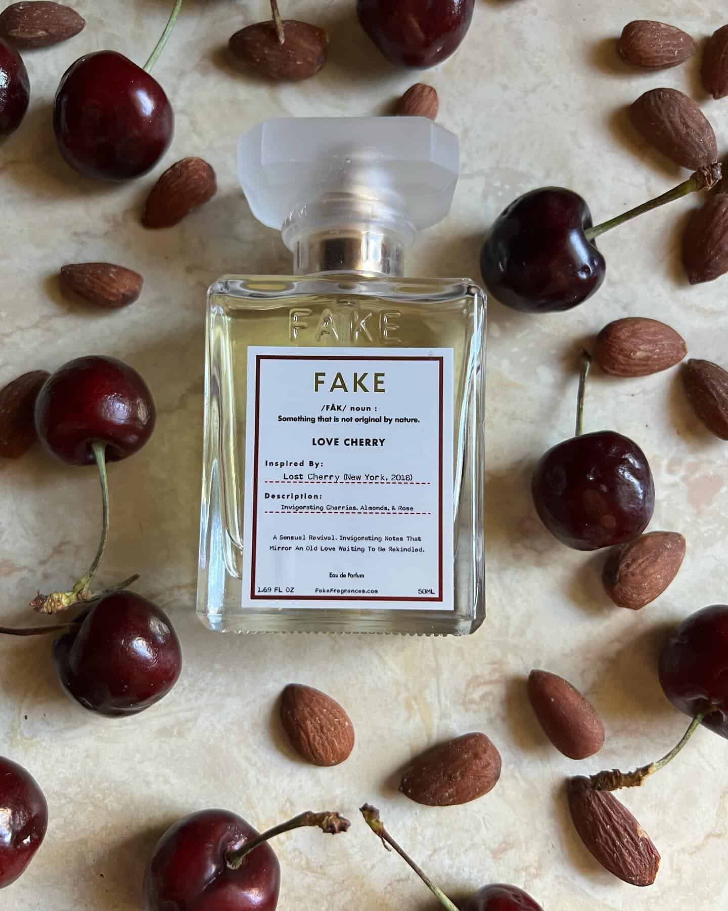 a bottle of love cherry parfum by fake surrounded by cherries and almonds