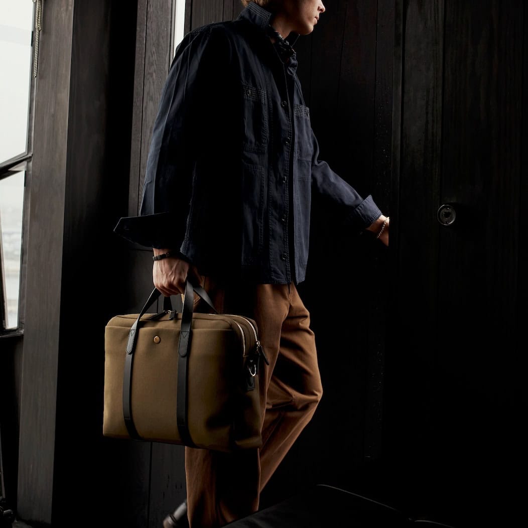 man going out the door and carrying a Mismo M/S Endeavour briefcase