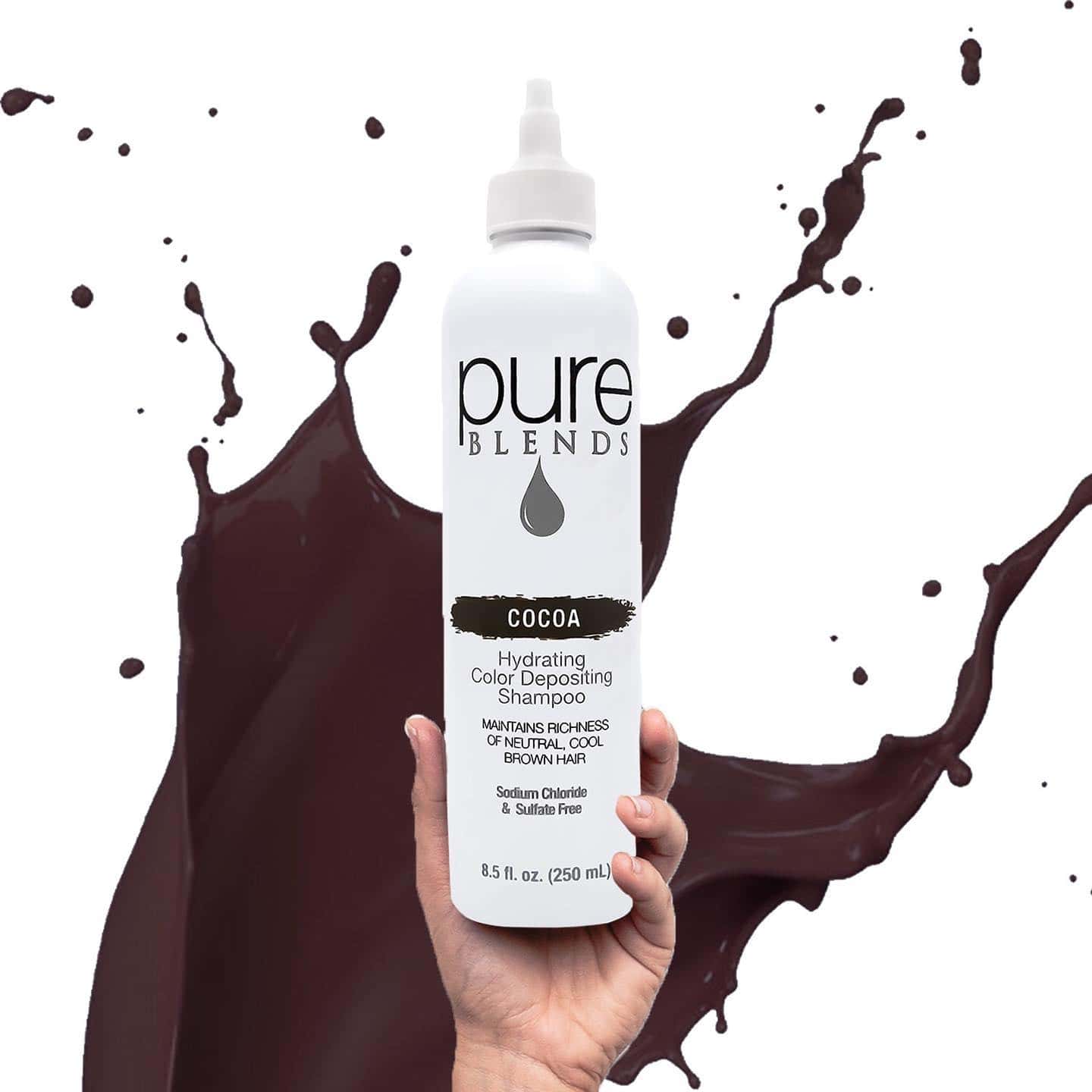 holding a bottle of pure blends cocoa color depositing shampoo