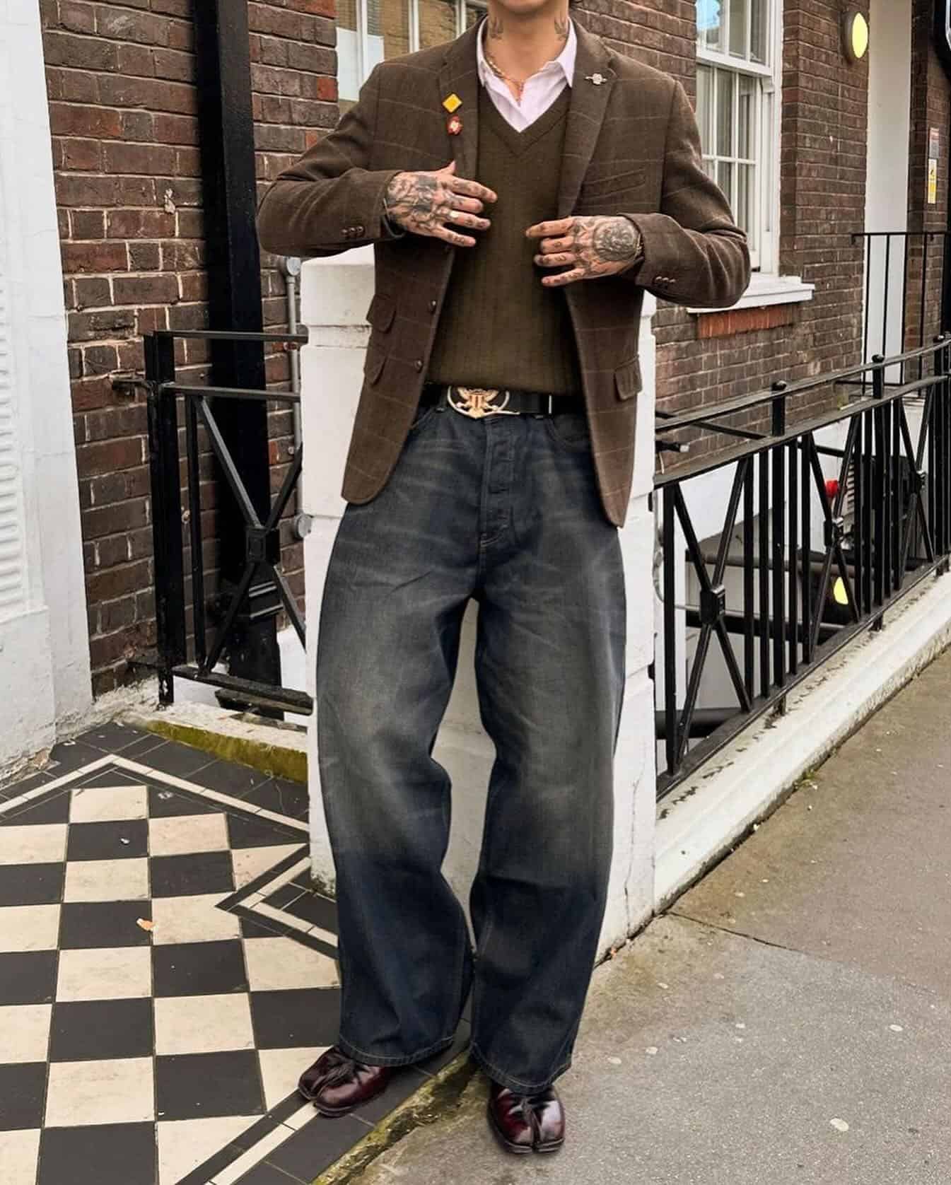 Vintage aesthetic: man wearing a brown checked blazer and wide legged jeans